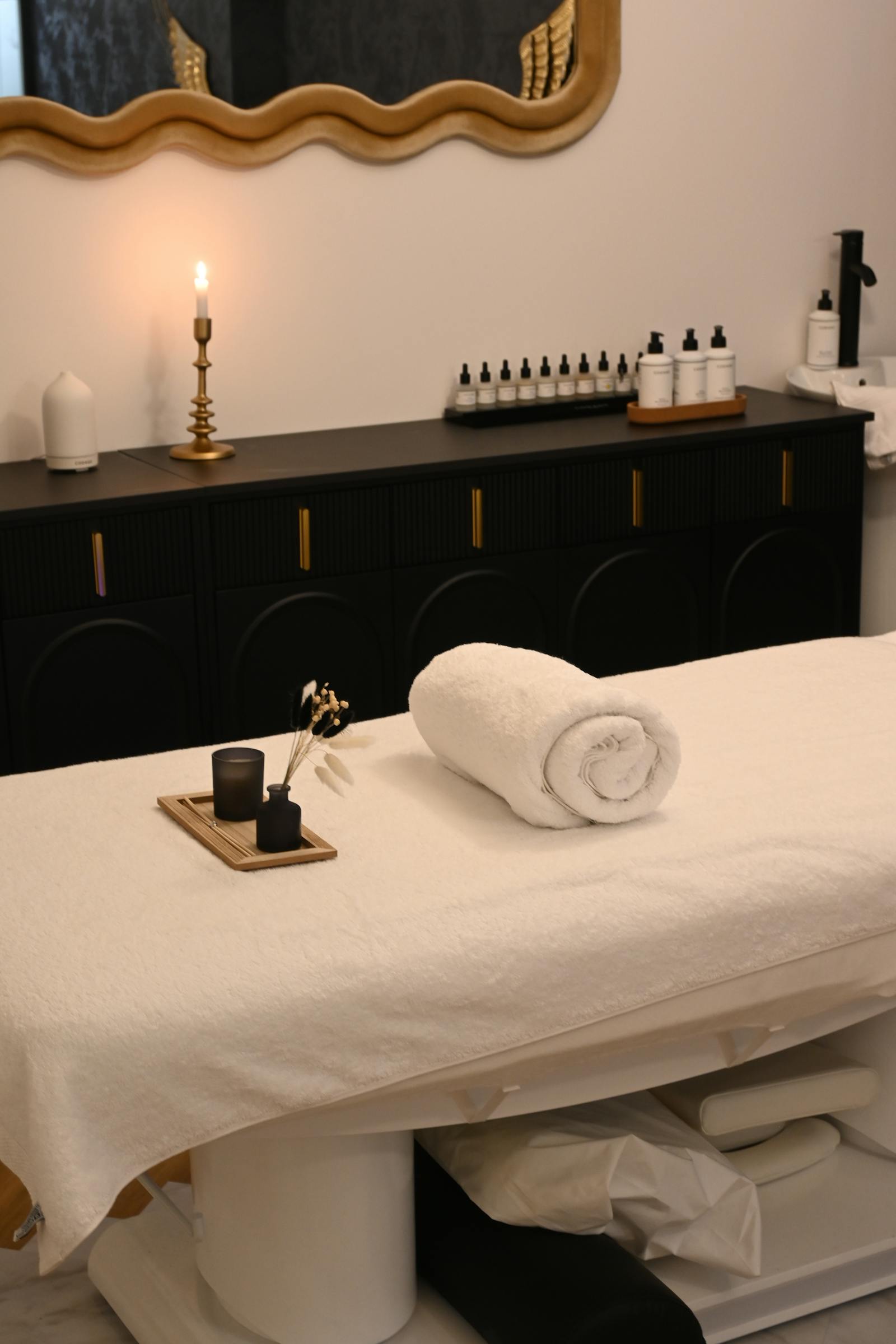 Serene massage room with candles and essential oils
